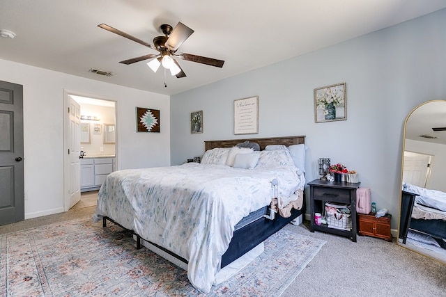 419 N Emerson St, San Angelo, TX 76903 - bedroom featuring light colored carpet, ensuite bathroom, baseboards, and ceiling fan