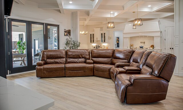 living room featuring french doors, coffered ceiling, a chandelier, light wood-type flooring, and beam ceiling