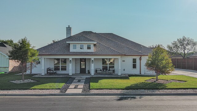 view of front of home with a front lawn and covered porch