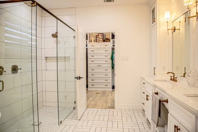 bathroom featuring vanity and a shower with shower door