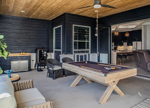 view of patio featuring an outdoor kitchen, ceiling fan, exterior bar, and outdoor lounge area