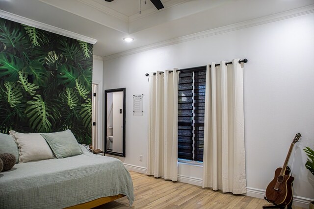 bedroom with ornamental molding and light hardwood / wood-style floors