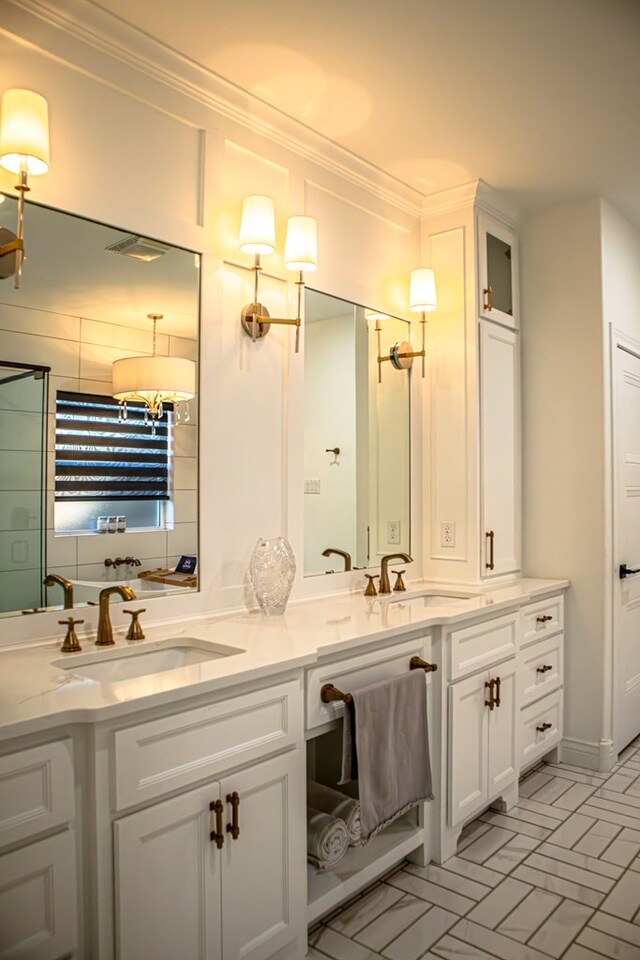 bathroom featuring crown molding and vanity