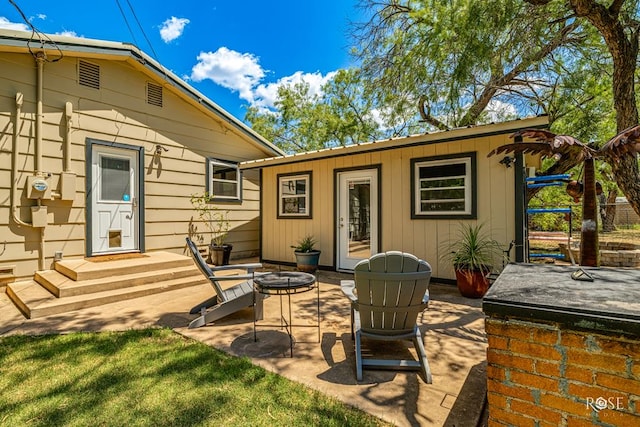 view of patio / terrace with an outbuilding and an outdoor fire pit