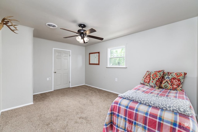 bedroom with baseboards, visible vents, carpet, and ceiling fan
