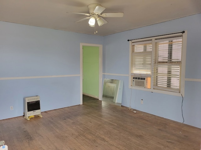 unfurnished room featuring heating unit, hardwood / wood-style floors, cooling unit, and ceiling fan