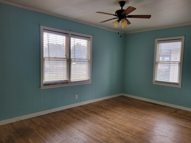 spare room featuring hardwood / wood-style flooring, plenty of natural light, and ornamental molding