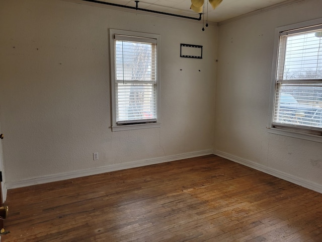 empty room with crown molding, hardwood / wood-style floors, and ceiling fan