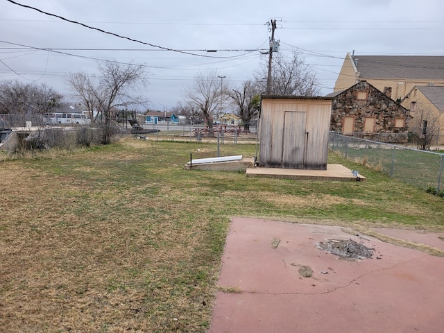 view of yard with a shed and a patio area