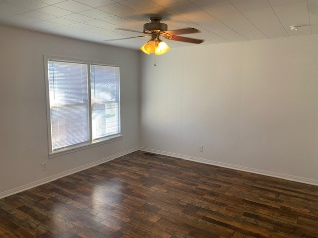 spare room with ceiling fan and dark hardwood / wood-style flooring