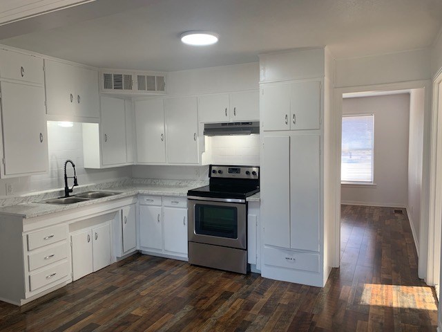 kitchen with white cabinetry, sink, dark wood-type flooring, and electric stove