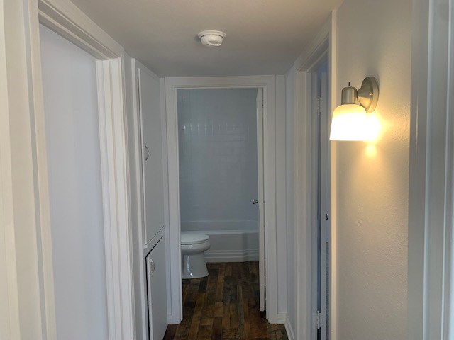 corridor featuring dark hardwood / wood-style flooring