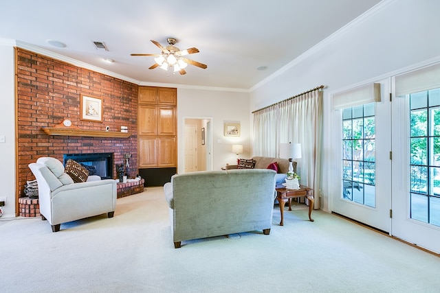 living area with a fireplace, ceiling fan, crown molding, visible vents, and light carpet