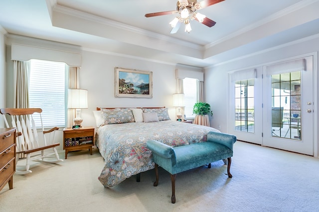 bedroom featuring access to exterior, carpet floors, ornamental molding, and a tray ceiling