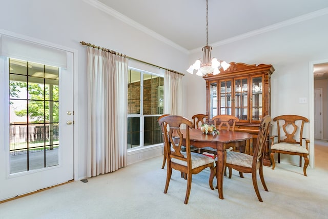 dining space with baseboards, light carpet, an inviting chandelier, and crown molding