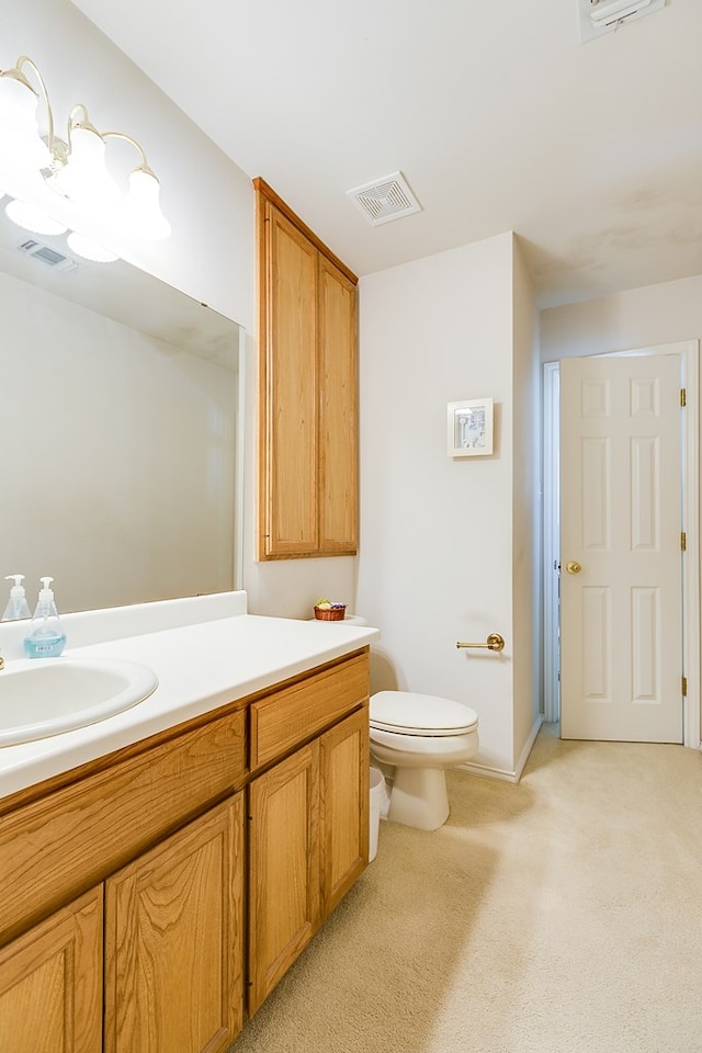 bathroom with visible vents, toilet, and vanity