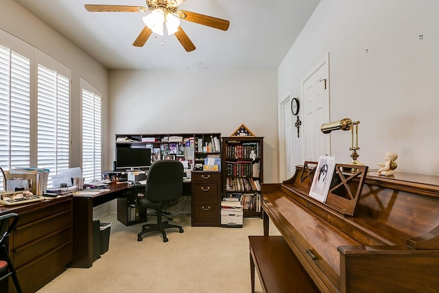 office space featuring light carpet and ceiling fan