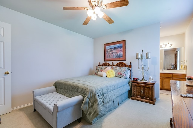 bedroom featuring a ceiling fan, ensuite bath, and light colored carpet