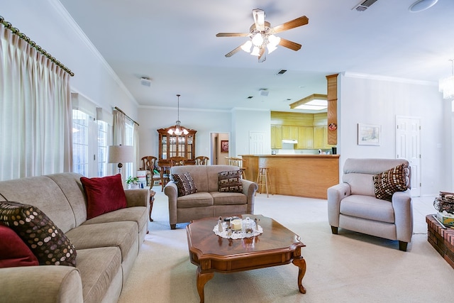 living room with crown molding, visible vents, light colored carpet, and ceiling fan with notable chandelier
