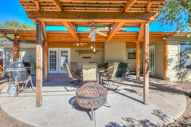 view of patio featuring french doors, ceiling fan, and an outdoor fire pit