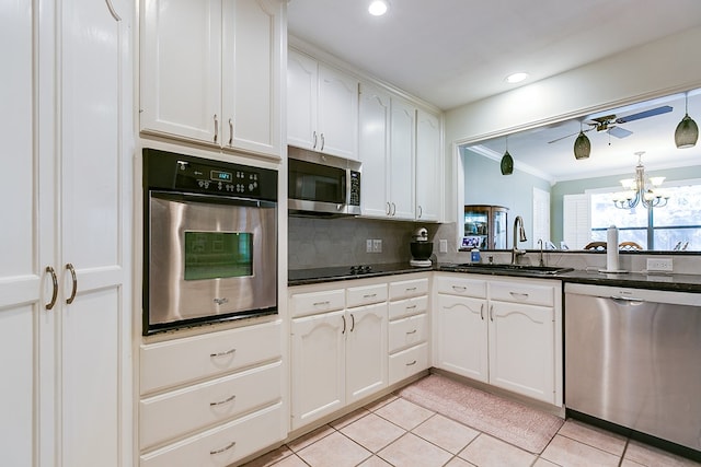 kitchen featuring white cabinetry, sink, light tile patterned floors, and stainless steel appliances