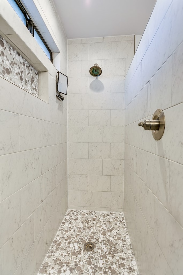 bathroom with tiled shower