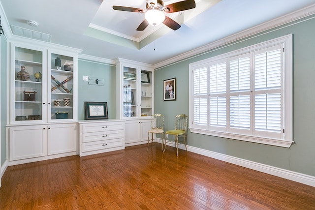 unfurnished room with ornamental molding, a wealth of natural light, dark hardwood / wood-style flooring, and a tray ceiling