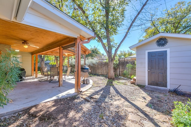 view of yard featuring a storage shed and a patio