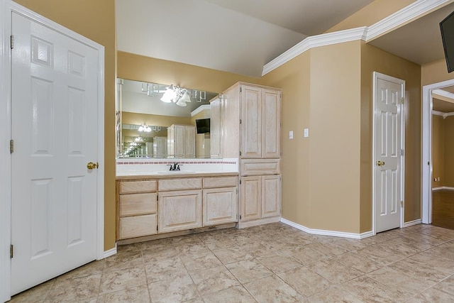 bathroom featuring tile patterned flooring, vaulted ceiling, vanity, and baseboards