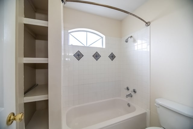 bathroom featuring tub / shower combination and toilet