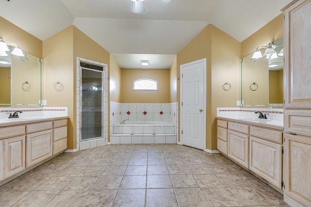 full bath with lofted ceiling, a shower stall, a sink, and a bath