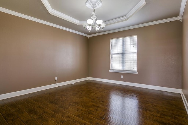 unfurnished room with baseboards, a raised ceiling, dark wood-style floors, crown molding, and a notable chandelier