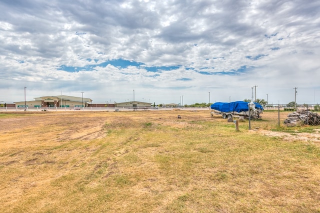 view of yard featuring a rural view and fence