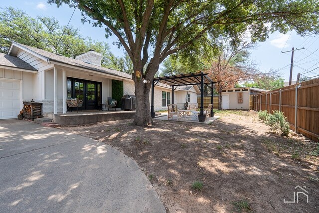 exterior space with a patio, a storage unit, and a pergola