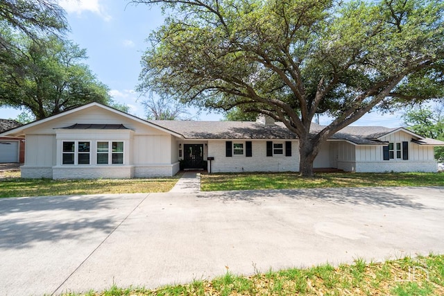 ranch-style house with a garage and a front yard