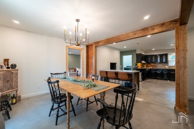 dining area featuring an inviting chandelier and concrete floors