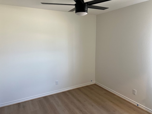 spare room with hardwood / wood-style floors and ceiling fan