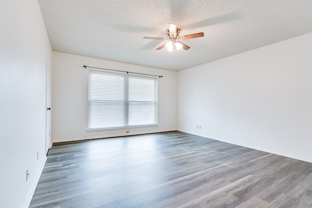2472-D University Ave, San Angelo, TX 76904 - unfurnished room with ceiling fan, wood finished floors, a textured ceiling, and baseboards