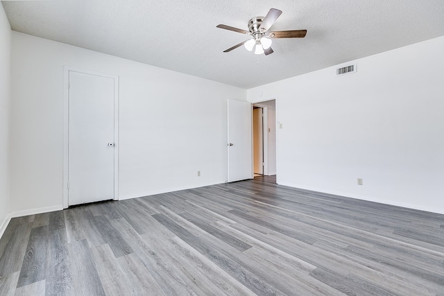 2472-D University Ave, San Angelo, TX 76904 - unfurnished room with a ceiling fan, wood finished floors, a textured ceiling, and baseboards