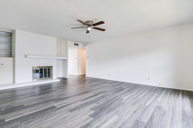 2472-D University Ave, San Angelo, TX 76904 - unfurnished living room with a ceiling fan, wood finished floors, a fireplace, and baseboards