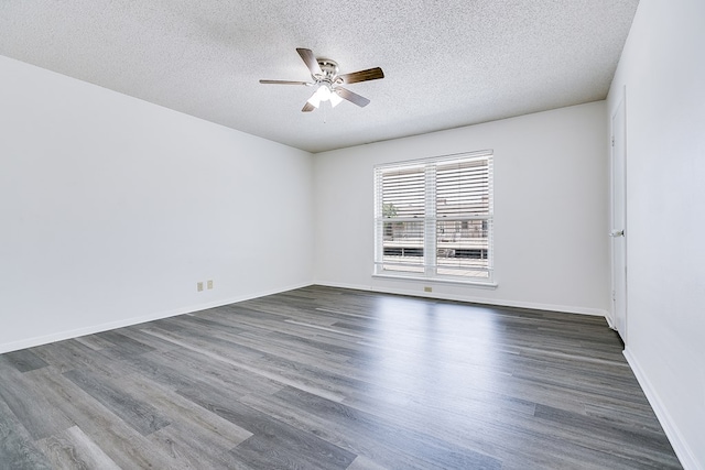 2472-D University Ave, San Angelo, TX 76904 - spare room featuring a ceiling fan, a textured ceiling, dark wood-style floors, and baseboards