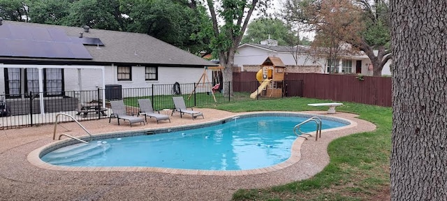 view of pool featuring a playground, a lawn, a fenced backyard, a patio area, and a fenced in pool