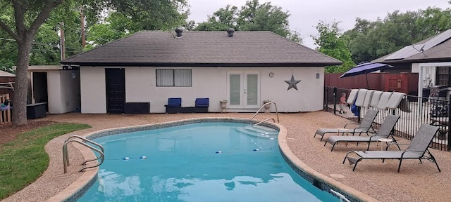 view of pool featuring a patio, french doors, and a fenced in pool