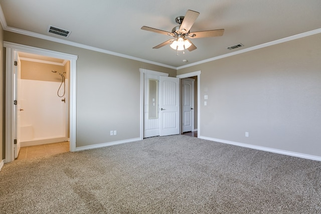 unfurnished bedroom featuring carpet floors, ornamental molding, visible vents, and baseboards