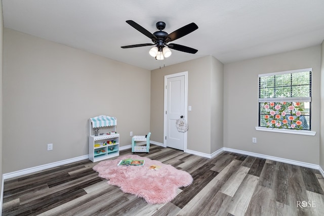 recreation room with dark wood-type flooring and ceiling fan