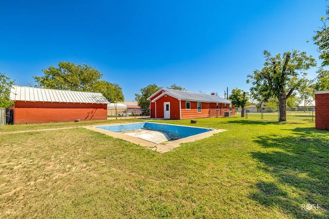 view of pool with an outdoor structure and a lawn