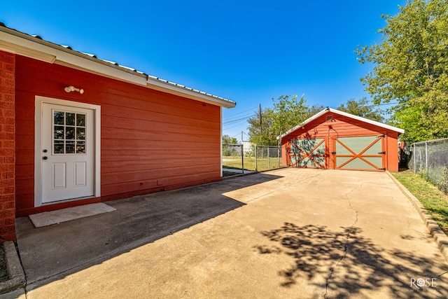 view of property exterior with a garage and an outdoor structure