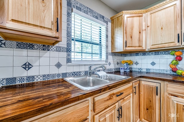 kitchen with tasteful backsplash, sink, and light brown cabinetry