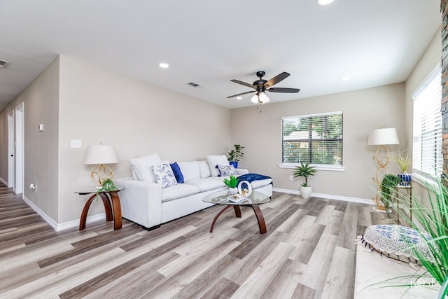 living room with ceiling fan and light hardwood / wood-style floors