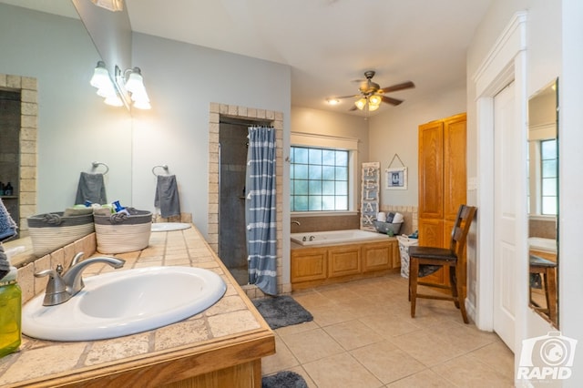 bathroom with shower with separate bathtub, tile patterned floors, ceiling fan, and vanity